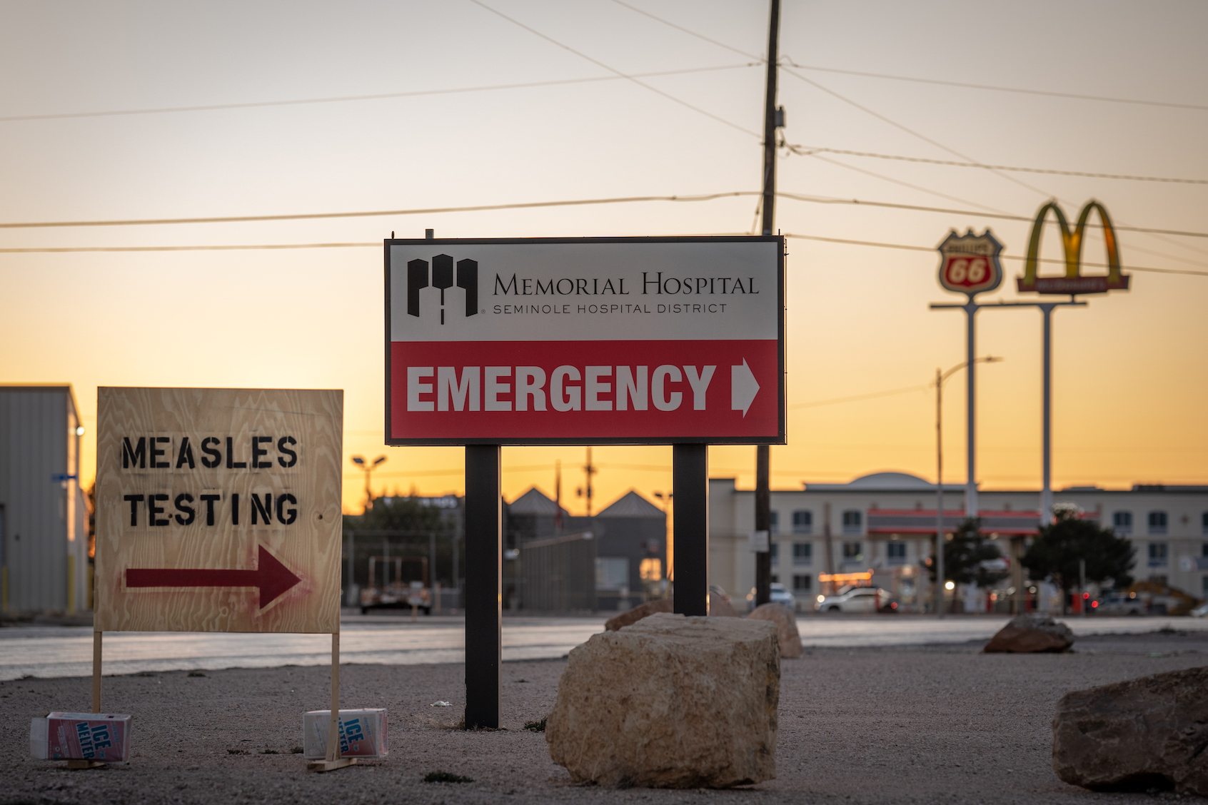 Signs point the way to measles testing in the parking lot of the Seminole Hospital District across from Wigwam Stadium on February 27, 2025 in Seminole, Texas. ((Photo by Jan Sonnenmair/Getty Images))
