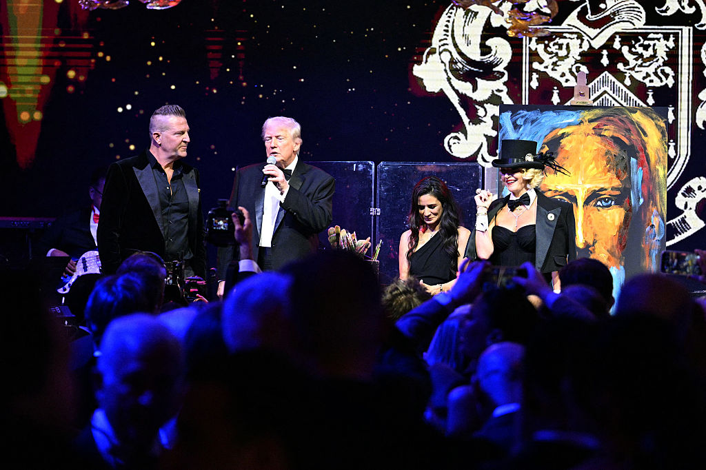 President Trump's New Year's Eve Gala included an auction of a painting of Jesus painted live at the event. He offered to sign it too. (Jim WATSON / Getty Images)
