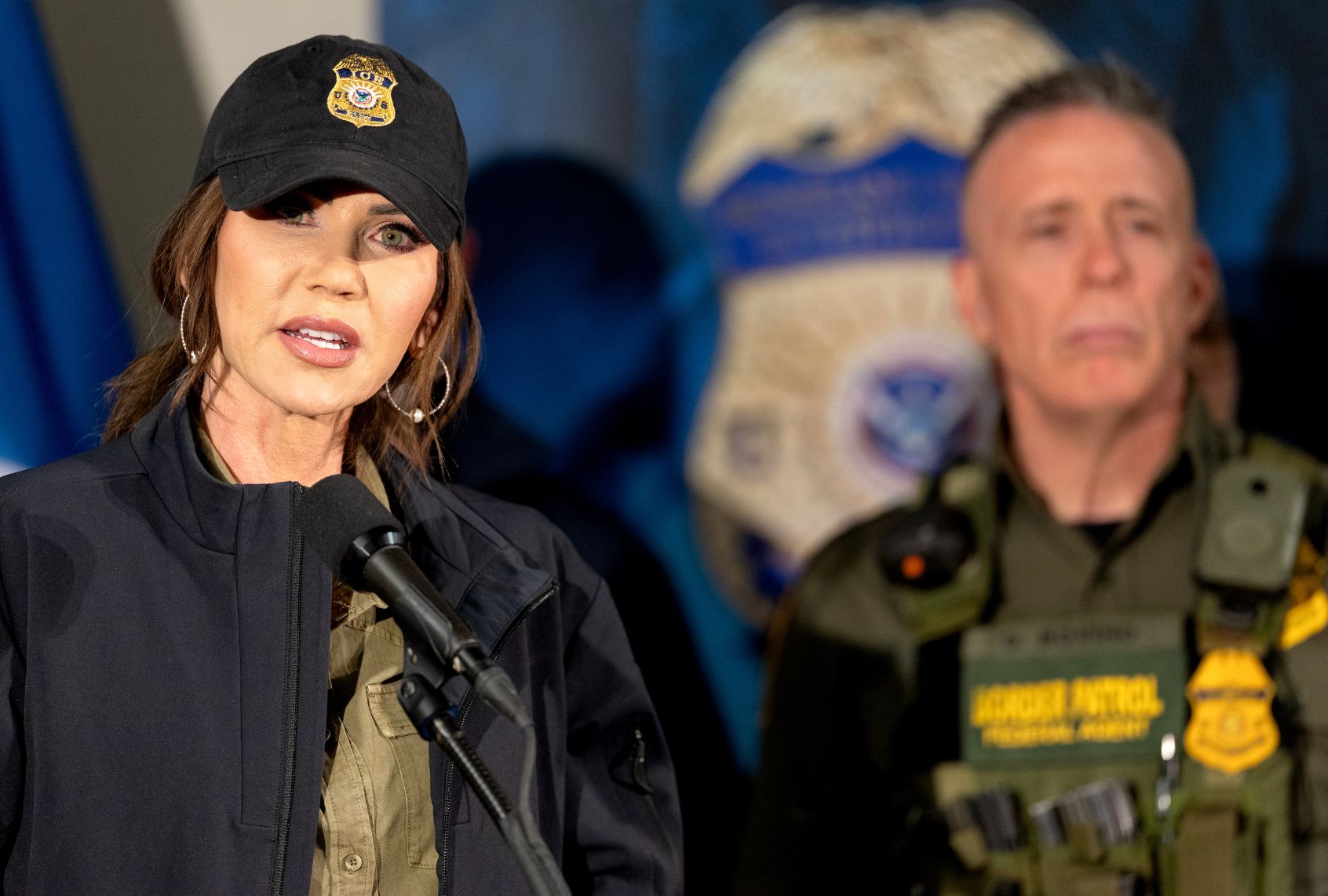 Secretary of Homeland Security Kristi Noem at the Whipple Federal Building in Minneapolis, Jan. 7, 2026. Behind her is Border Patrol official Greg Bovino. (Carlos Gonzalez/The Minnesota Star Tribune via Getty Images)