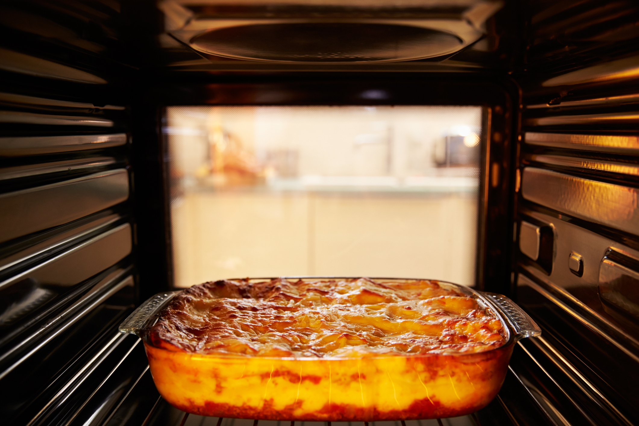 Lasagna in an oven (monkeybusinessimages/ Getty Images)