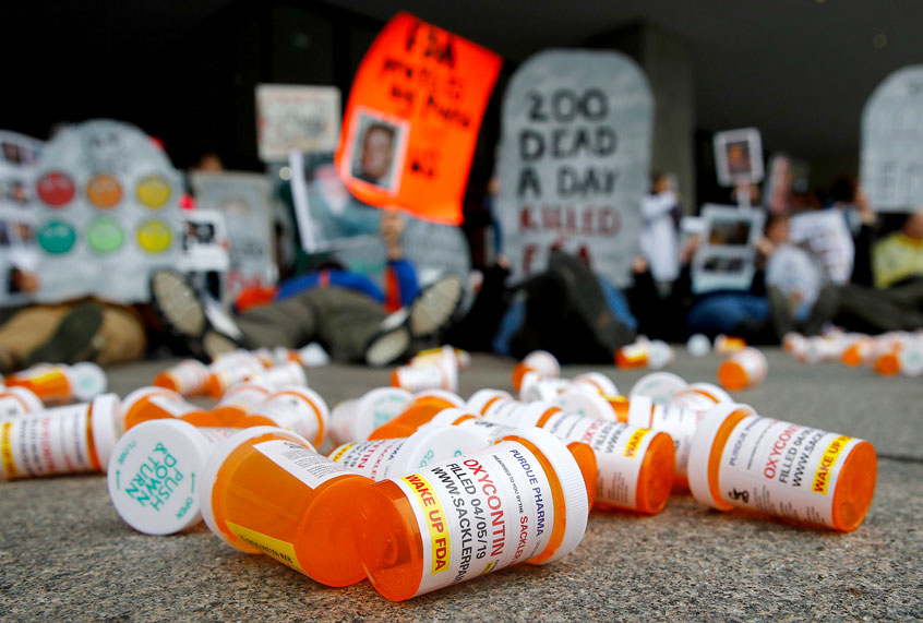 OxyContin pill bottles scattered in front of protestors of the opioid crisis. (AP Photo/Patrick Semansky)