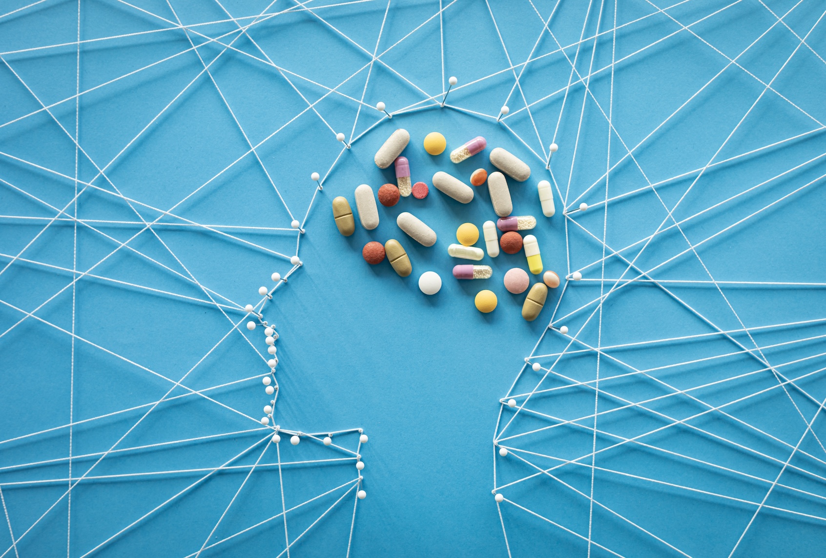 Pins and threads in the shape of a a human head. (Getty Images / solidcolours )
