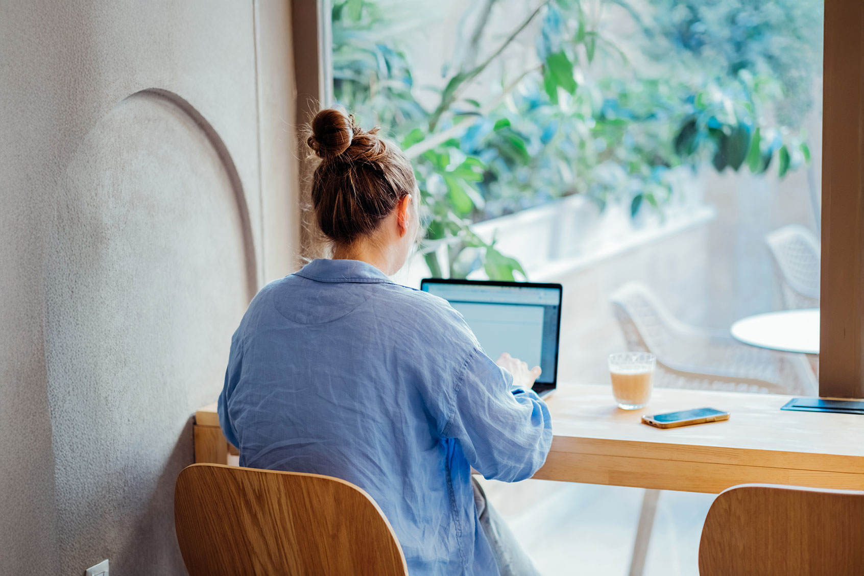 Woman working at her laptop (Getty Images/Mariia Siurtukova)