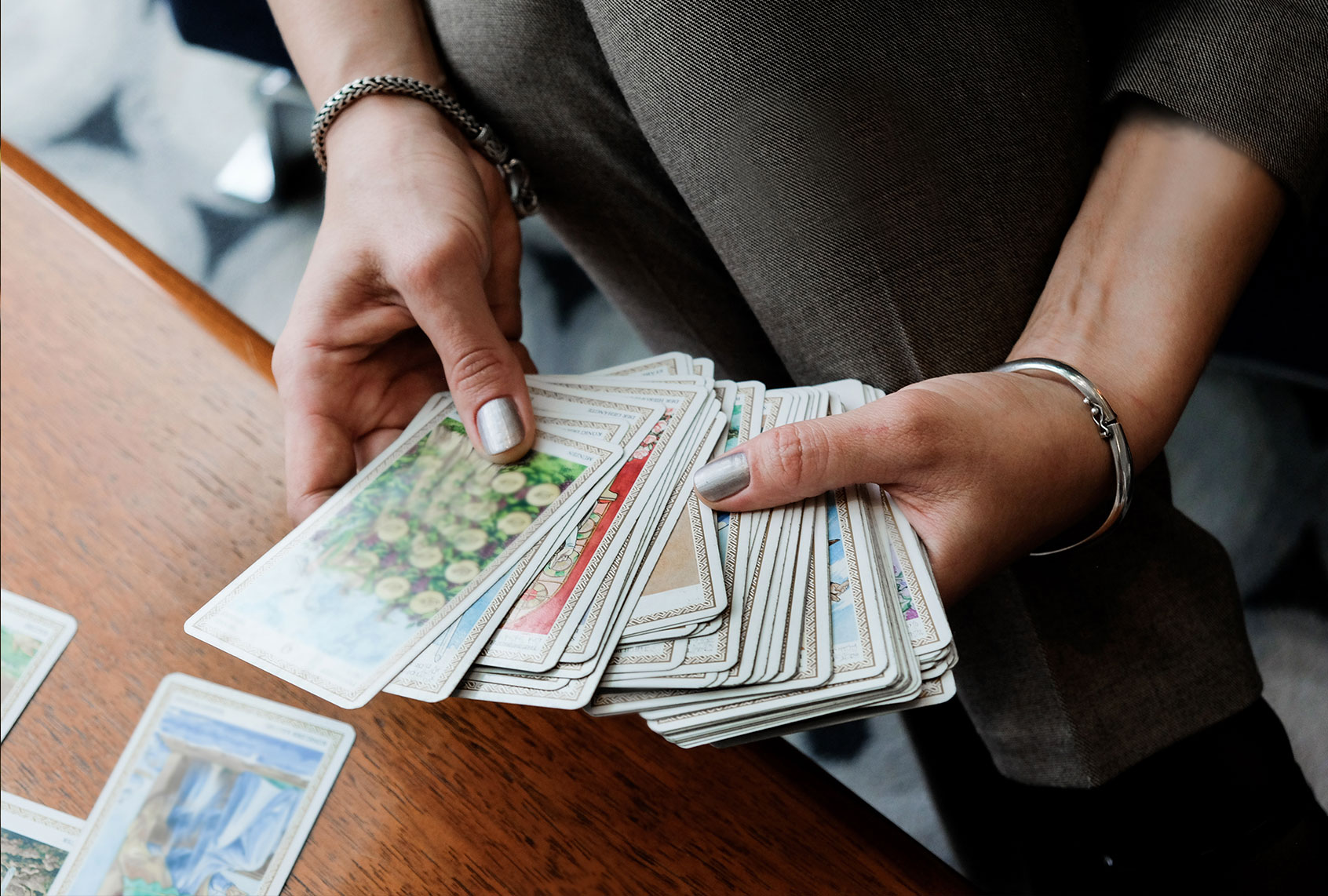 Woman holding tarot cards (Getty Images/Khrystynabohush)