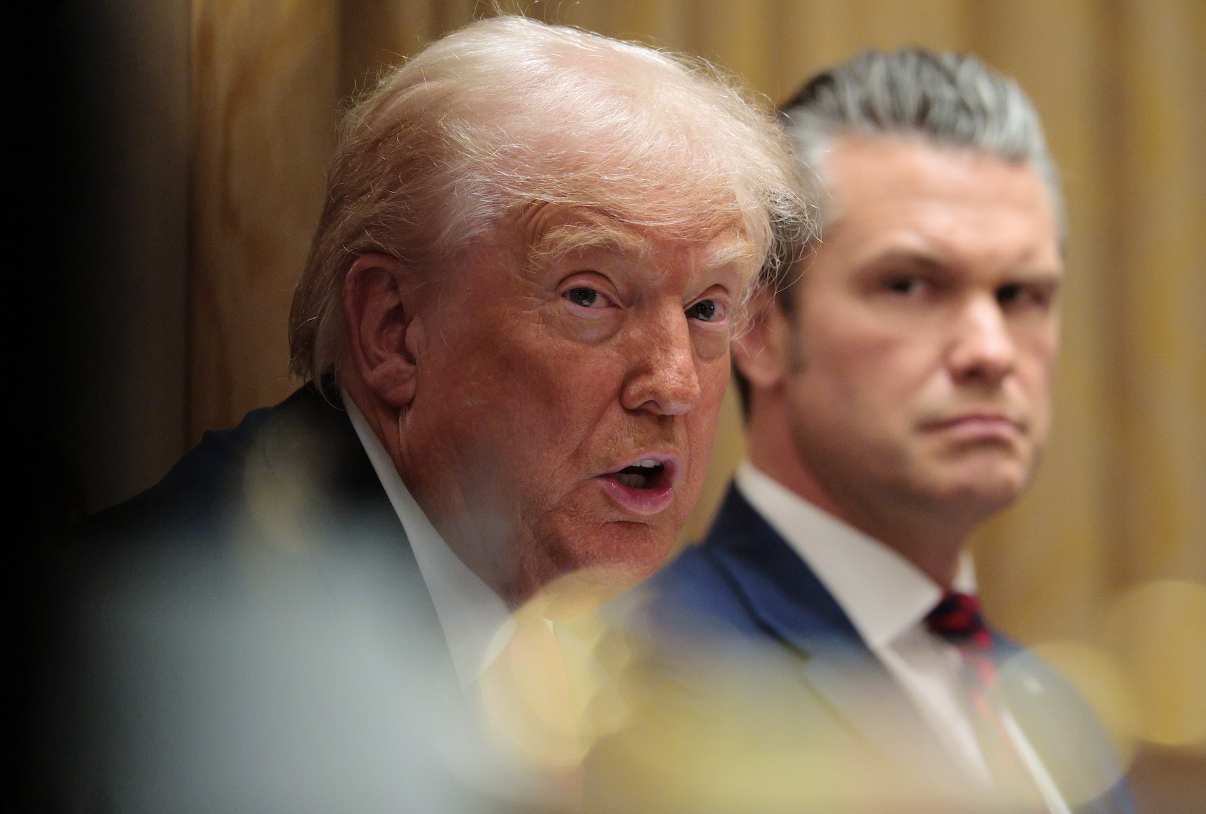 Secretary of War Pete Hegseth looks on as U.S. President Donald Trump speaks during a meeting of his Cabinet in the Cabinet Room of the White House on December 02, 2025 in Washington, DC. (Photo by Chip Somodevilla/Getty Images)